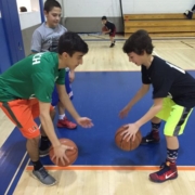 Two young basketball players dribbling