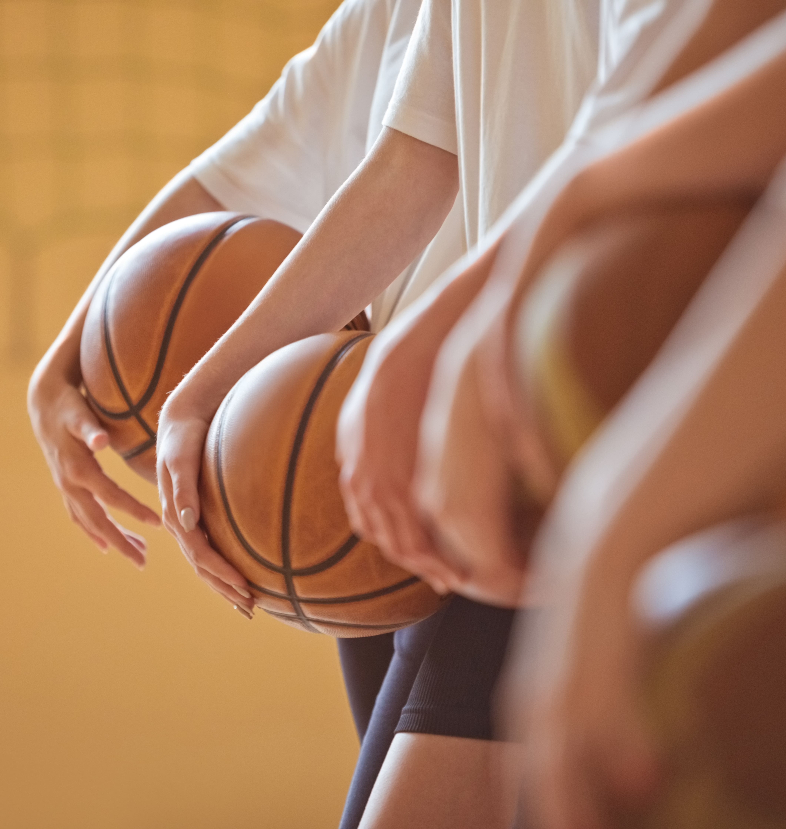 A row of kids holding basketballs