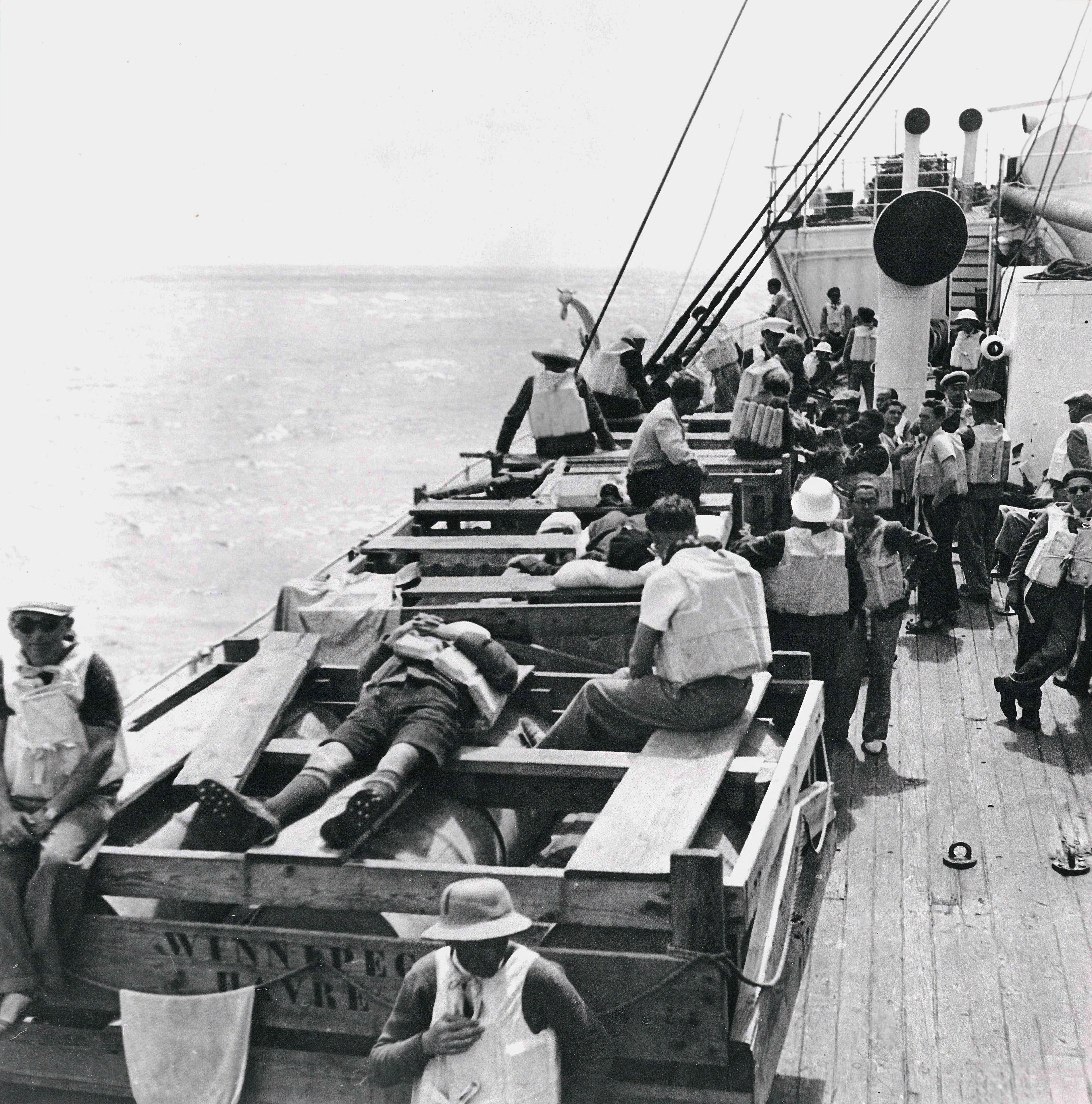 Black and white photograph of refugees on a boat