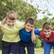 Group of five kids outside.